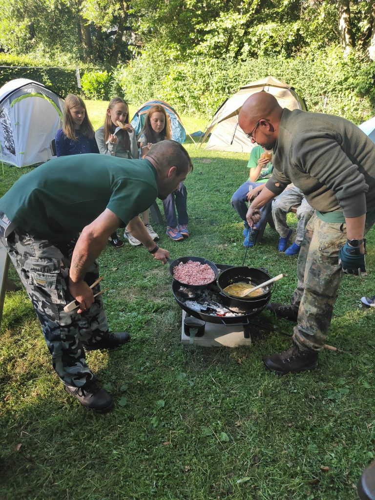 Gemeinsames Frühstück beim Naturcamp mit Dutch-Oven-Rührei